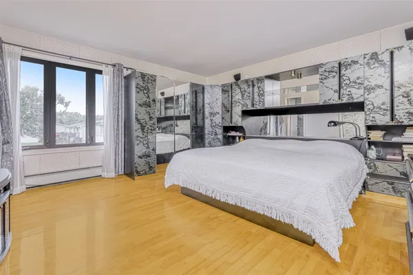 a bed sitting in a bedroom next to a window