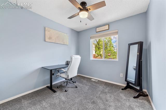 6525 Bismark Road Colorado Springs, CO 80922 - Photo 24 of 38 Carpeted second spare bedroom with ceiling fan