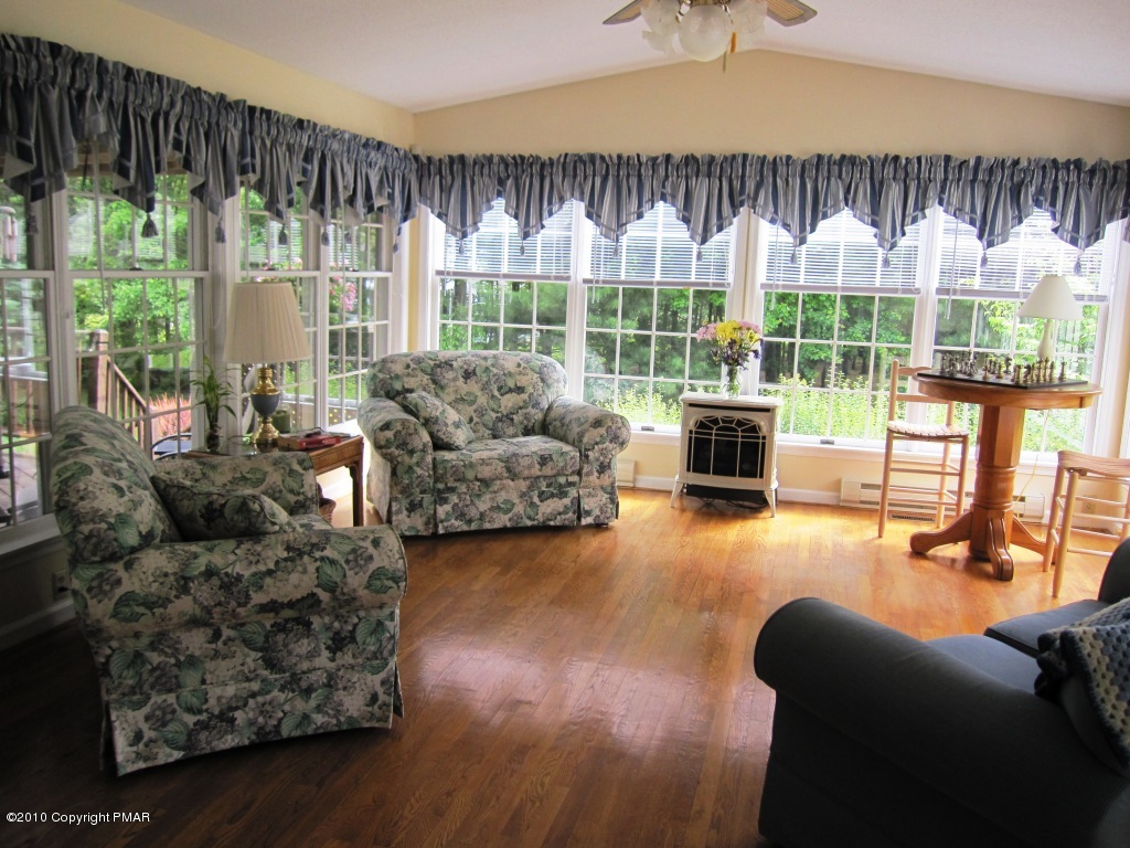 341 Tara Hill Road Bartonsville, PA 18321 - Photo 14 of 23 a living room with furniture fireplace and a large window