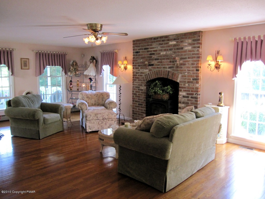 341 Tara Hill Road Bartonsville, PA 18321 - Photo 6 of 23 a living room with furniture and a fireplace
