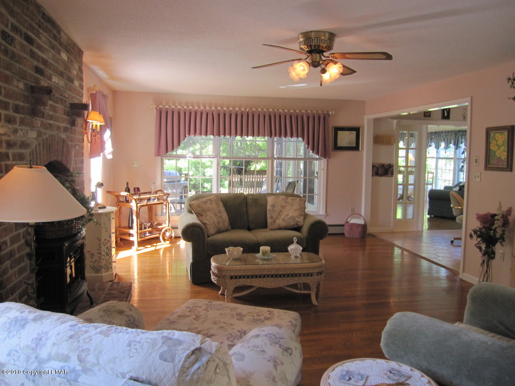 341 Tara Hill Road Bartonsville, PA 18321 - Photo 7 of 23 a living room with furniture fireplace and a large window