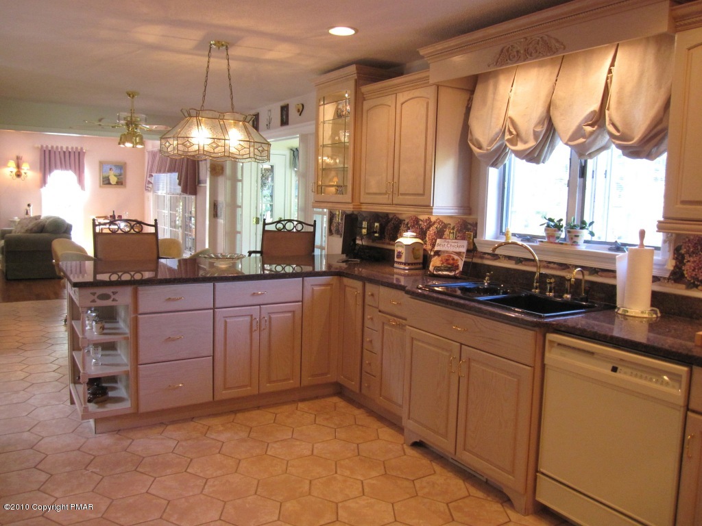 341 Tara Hill Road Bartonsville, PA 18321 - Photo 8 of 23 a kitchen with stainless steel appliances a sink and a large window