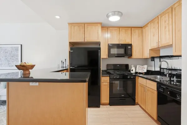 a kitchen with a stove a sink and a microwave