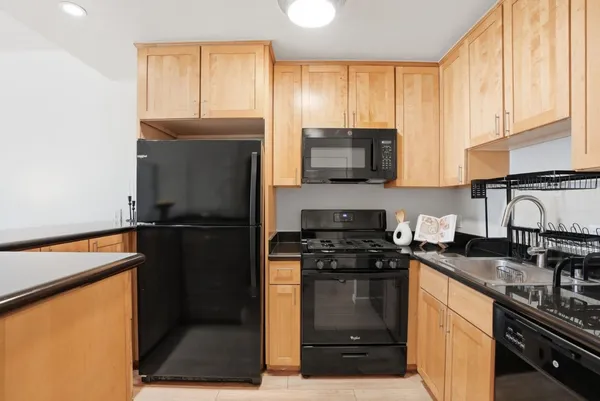 a kitchen with a refrigerator stove and microwave