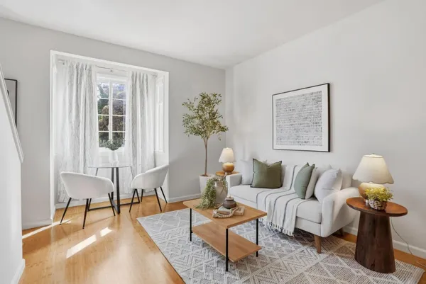 a living room with furniture and wooden floor
