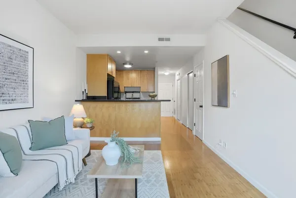 a living room with furniture and kitchen view
