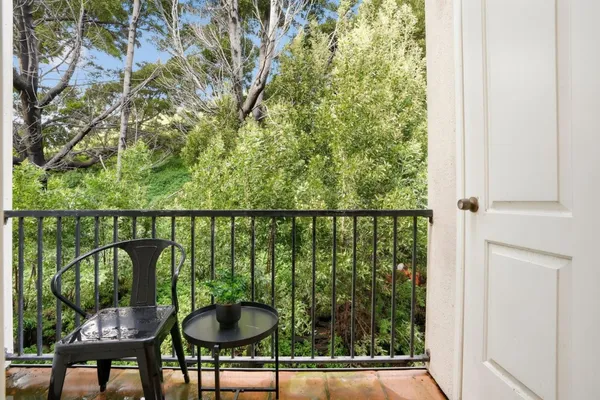 a balcony with table and chairs