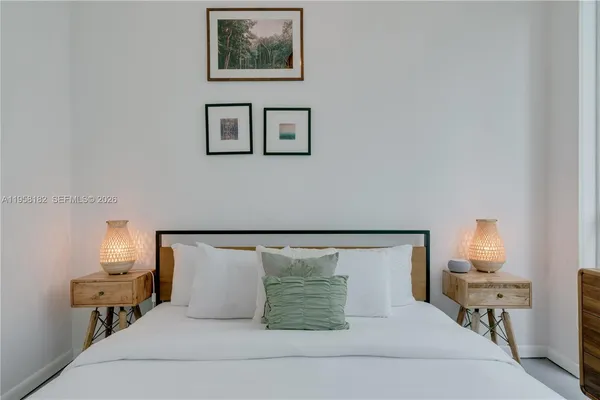 a bedroom with a bed and lamp