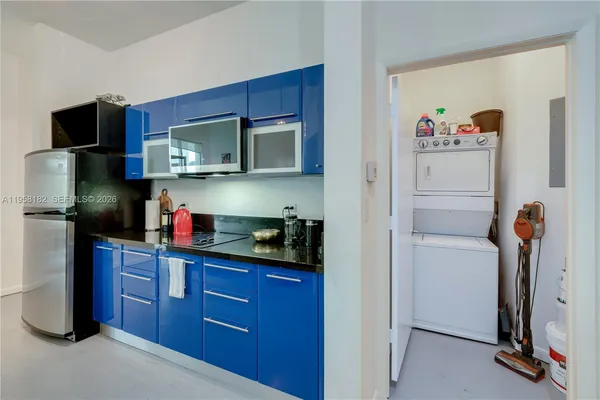 a kitchen with stainless steel appliances granite countertop a refrigerator and a microwave