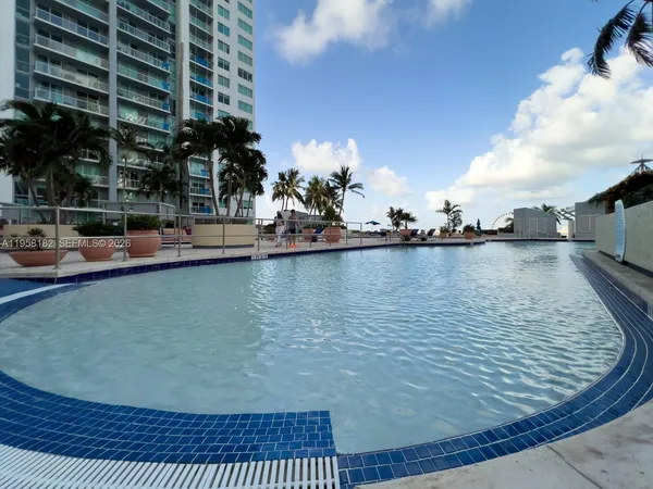 a view of a swimming pool with outdoor seating