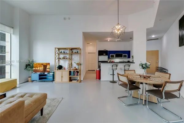 a view of a livingroom with furniture and a kitchen