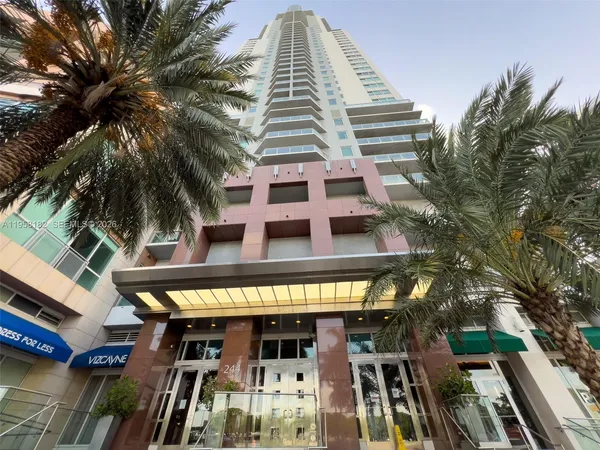 a view of a tall building with a tree