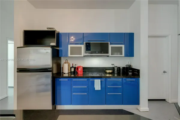 a kitchen with stainless steel appliances granite countertop a refrigerator and a microwave