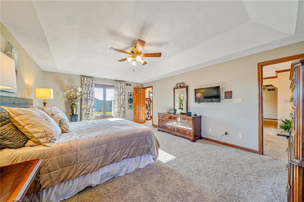 5600 Field Stream Drive Export, PA 15632 - Photo 30 of 43 a bedroom with a large bed and a chandelier