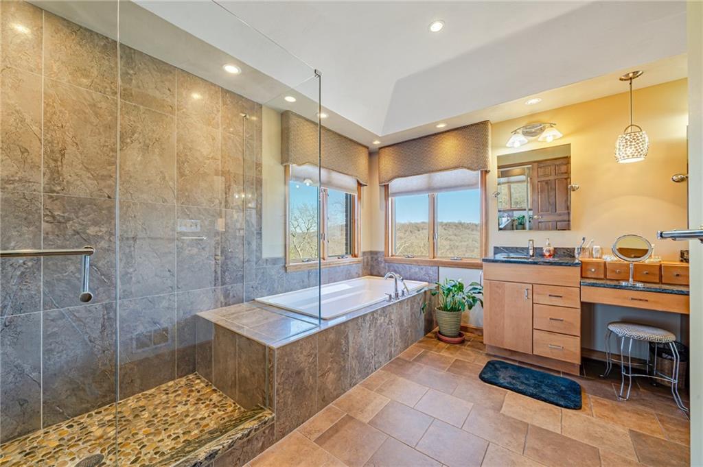 5600 Field Stream Drive Export, PA 15632 - Photo 32 of 43 a spacious bathroom with a double vanity sink a large mirror and a bathtub