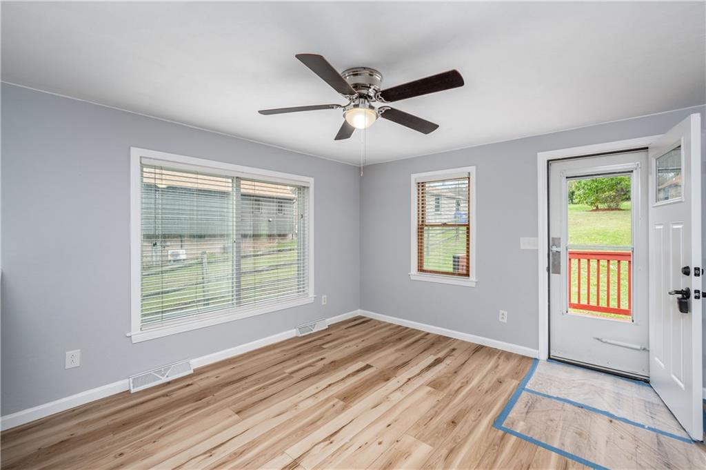226 Kilgallen Road Butler, PA 16002 - Photo 11 of 38 a view of an empty room with wooden floor and a window