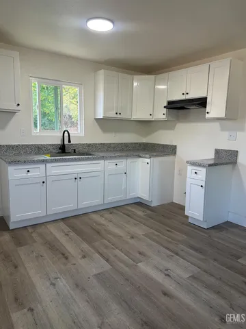 a kitchen with stainless steel appliances granite countertop a sink and cabinets