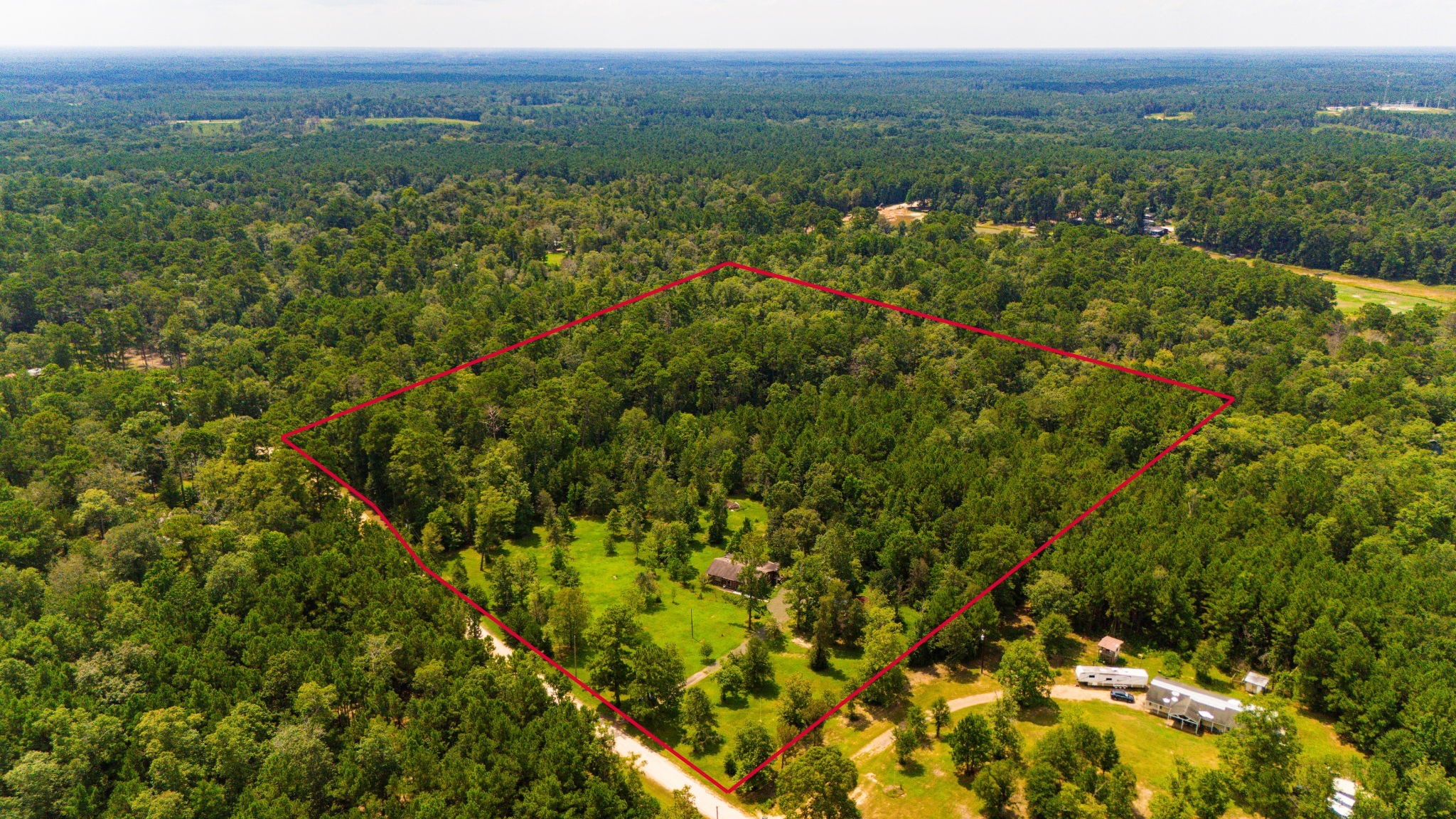 271 Ivanhoe Ranchettes Drive Ivanhoe, TX 75979 - Photo 2 of 40 a view of a city with lush green forest