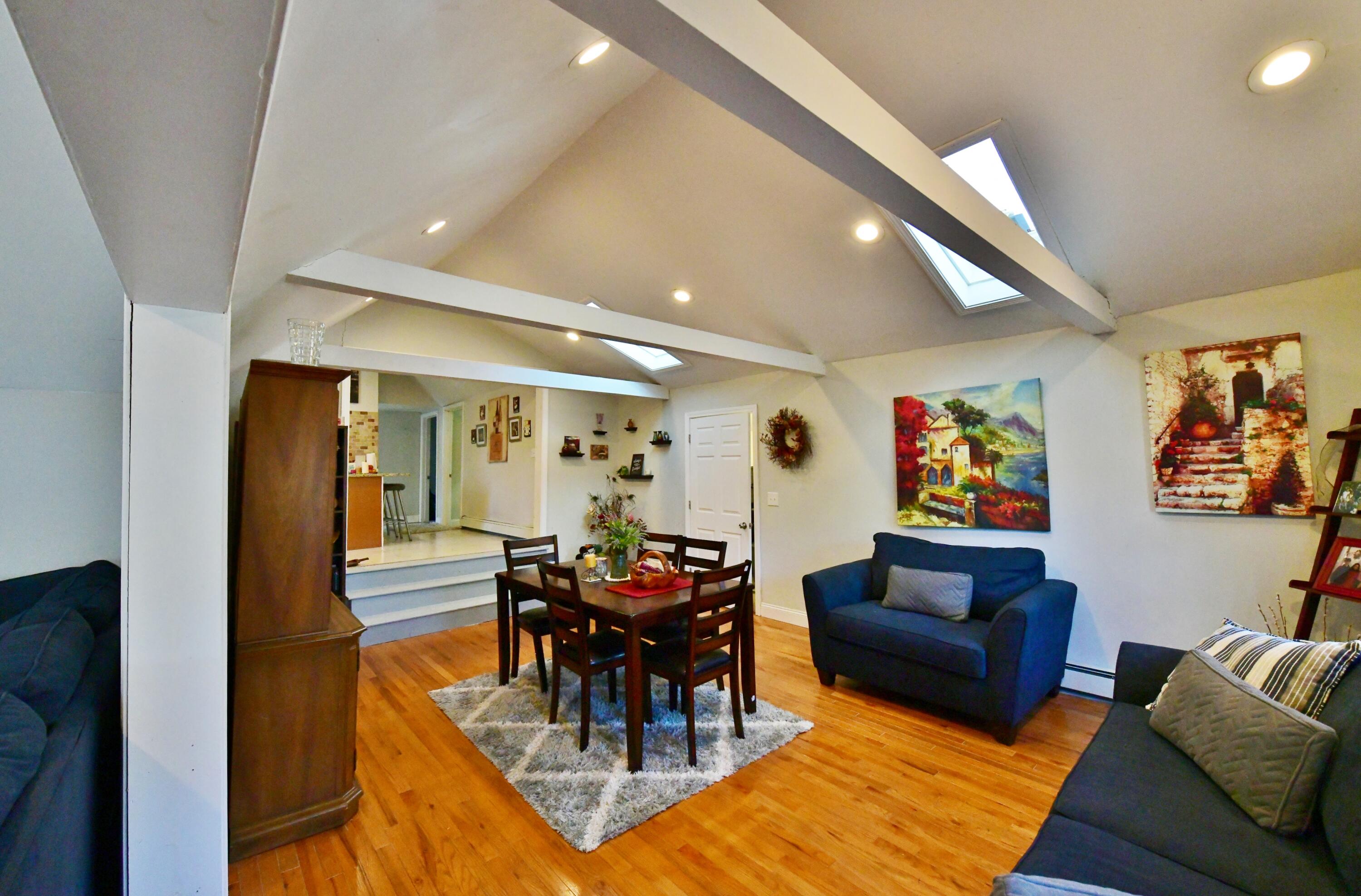 26 Old Monument Neck Road Bourne, MA 02532 - Photo 11 of 51 a living room with furniture a dining table and chairs with rug