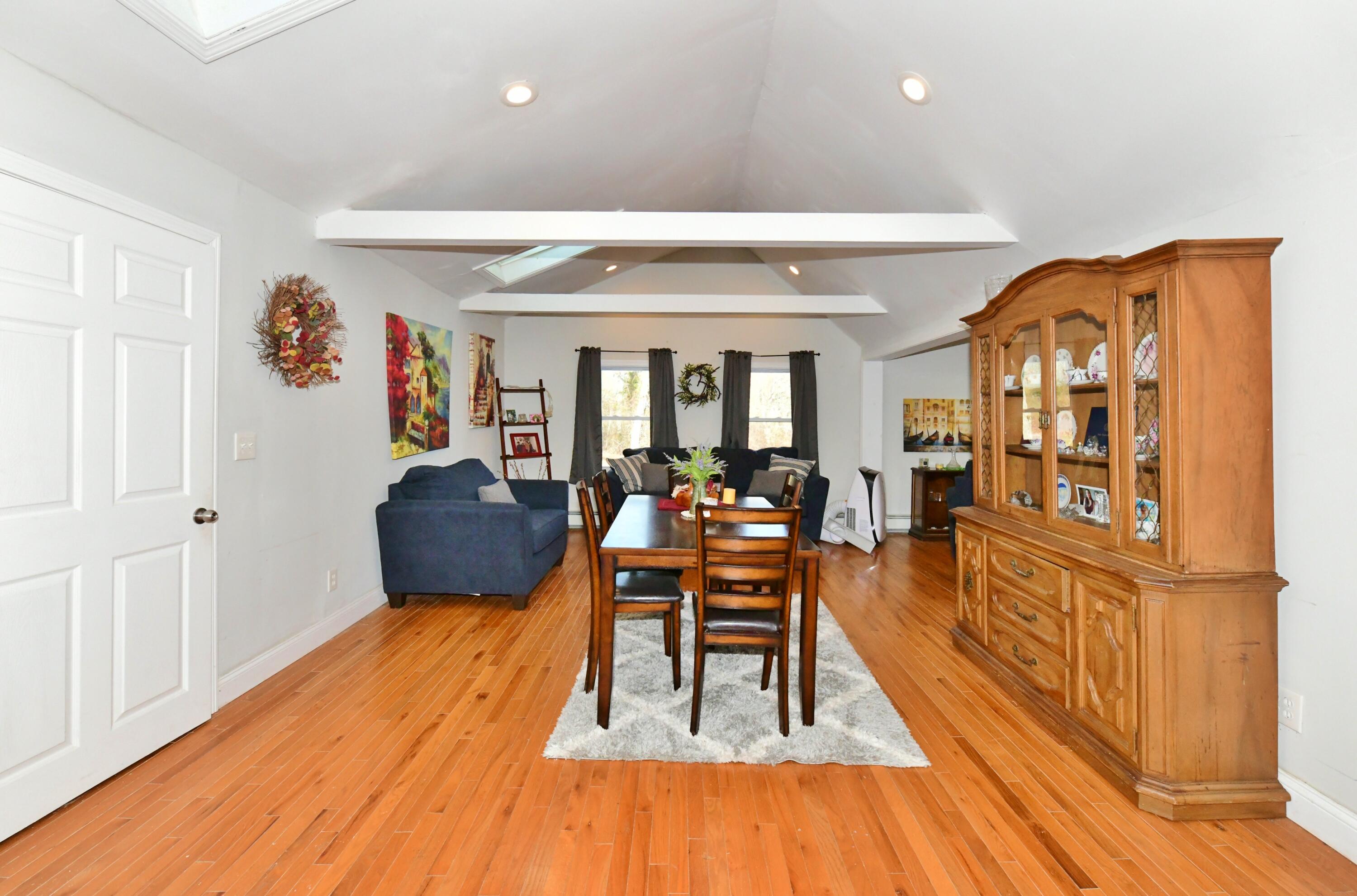 26 Old Monument Neck Road Bourne, MA 02532 - Photo 13 of 51 a living room with furniture a wooden floor and next to a window