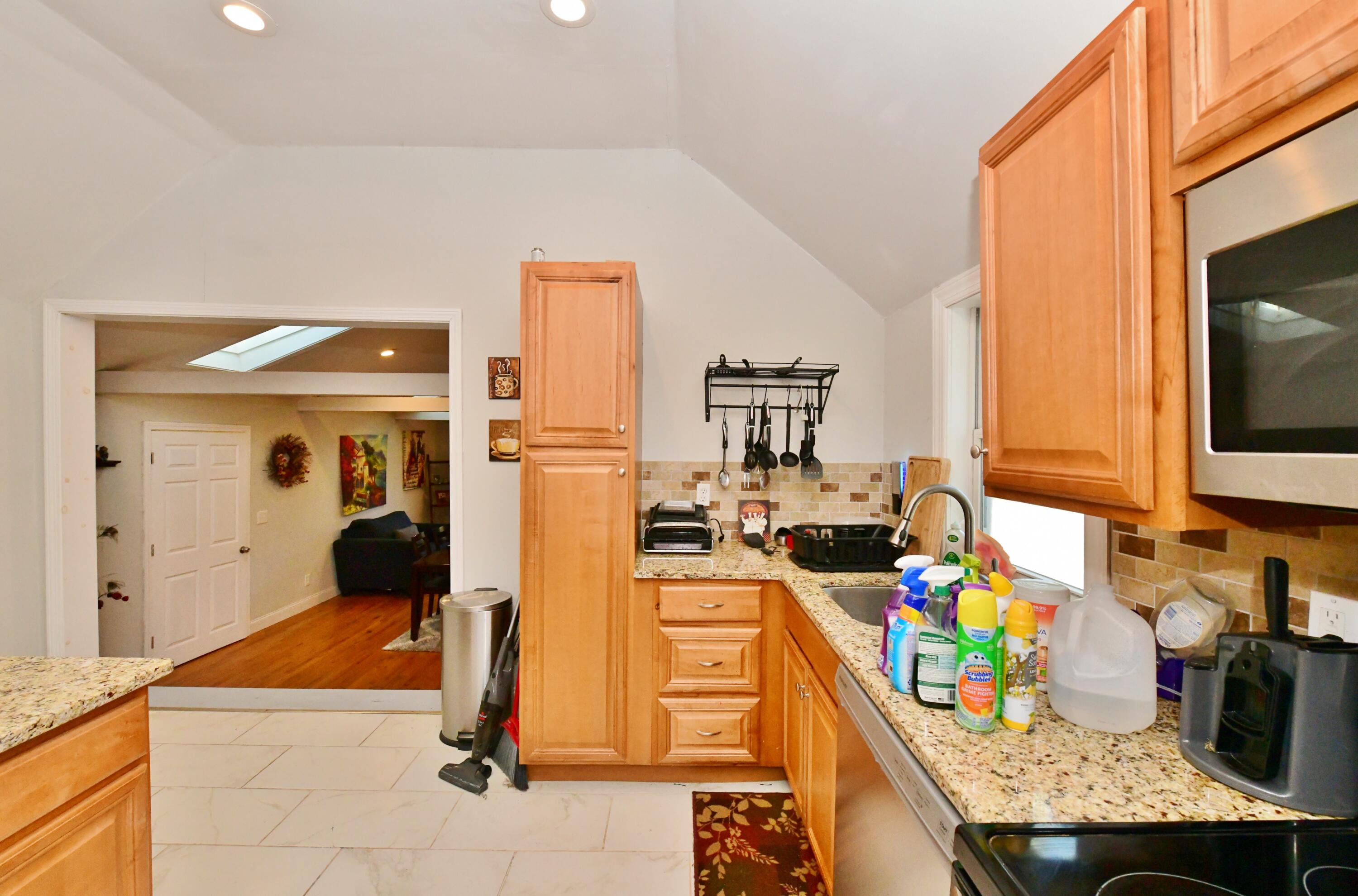26 Old Monument Neck Road Bourne, MA 02532 - Photo 20 of 51 a kitchen with stainless steel appliances kitchen island granite countertop a stove refrigerator and microwave