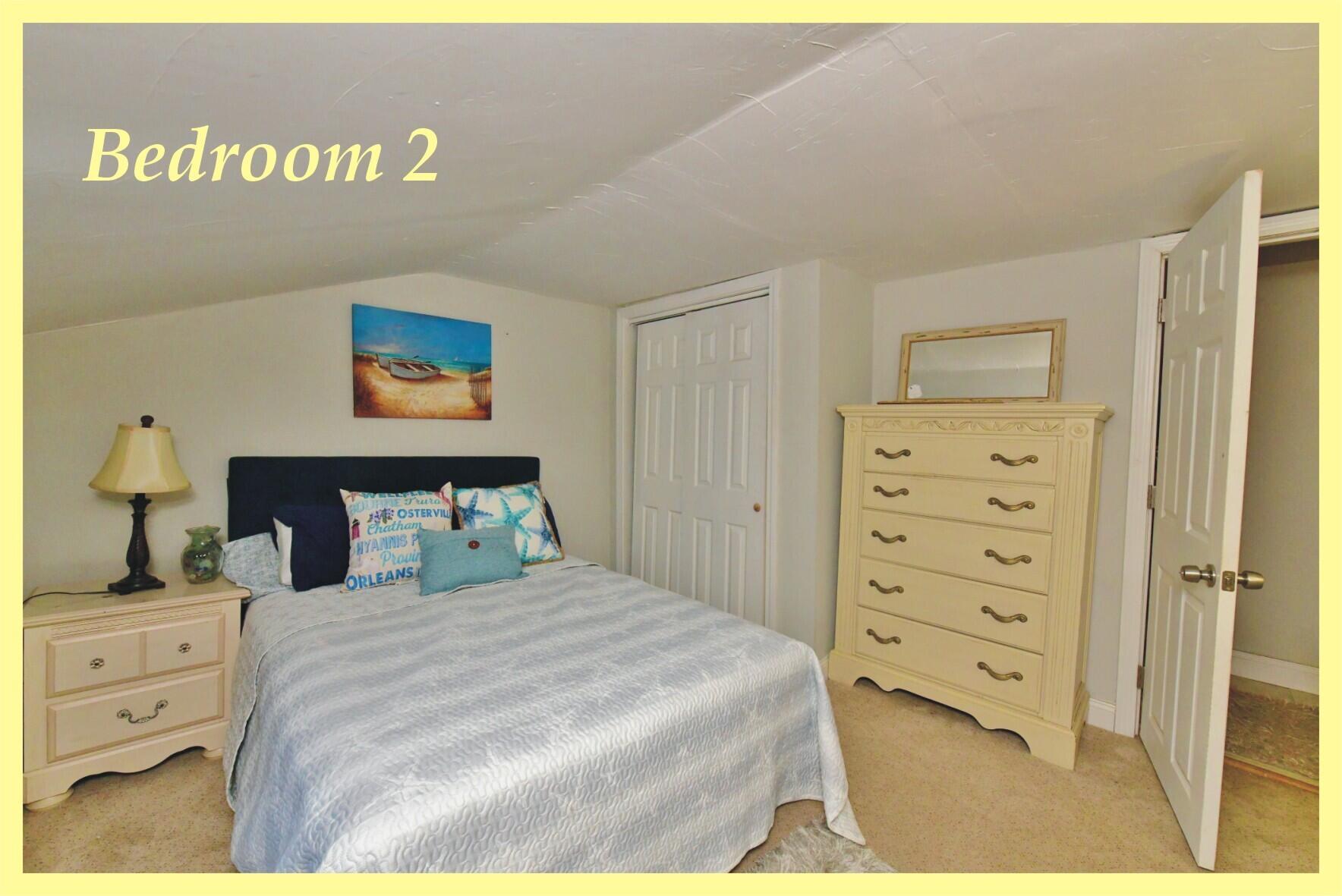 26 Old Monument Neck Road Bourne, MA 02532 - Photo 23 of 51 a bedroom with a bed and a cabinet