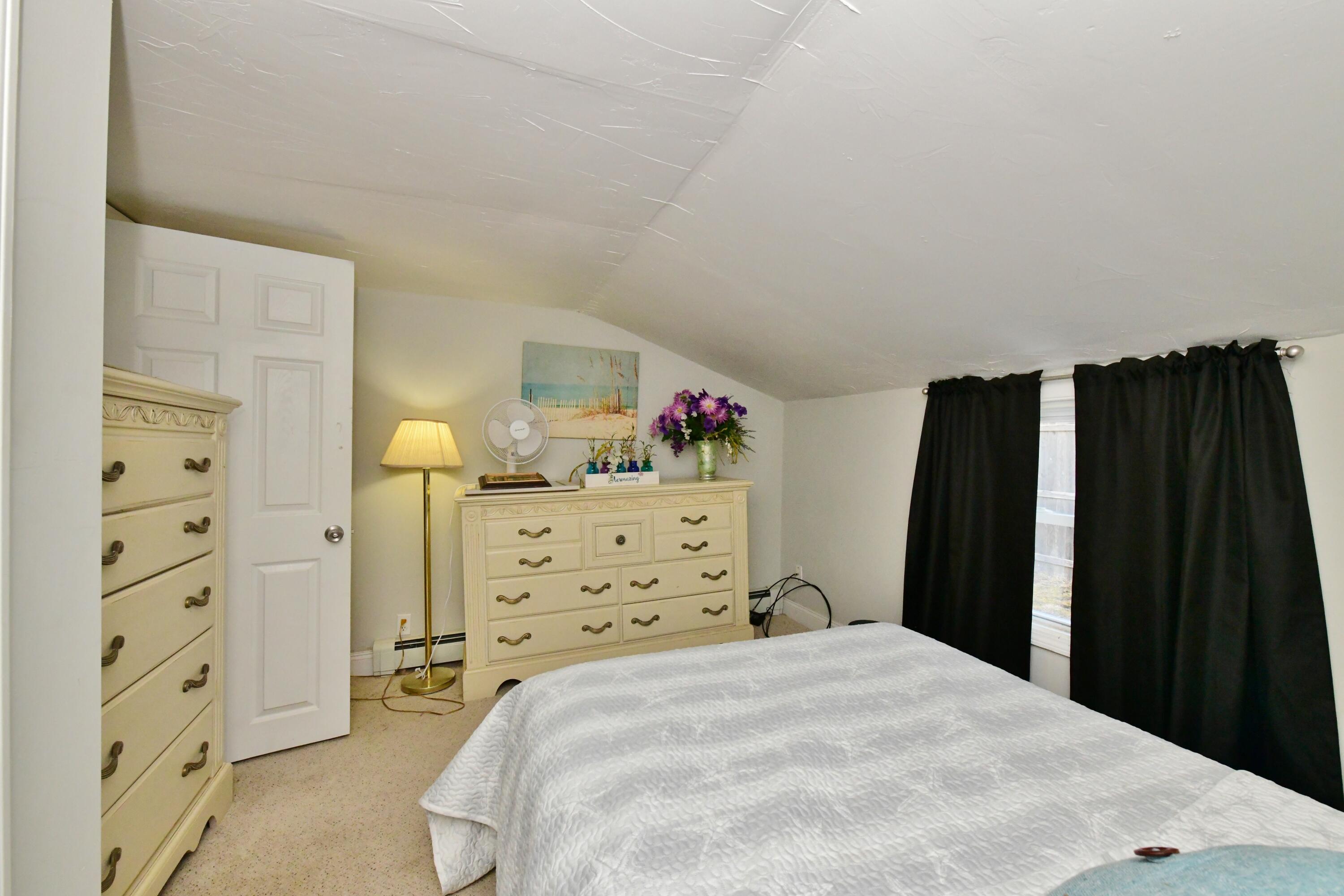26 Old Monument Neck Road Bourne, MA 02532 - Photo 24 of 51 a bed room with a bed and a cabinets