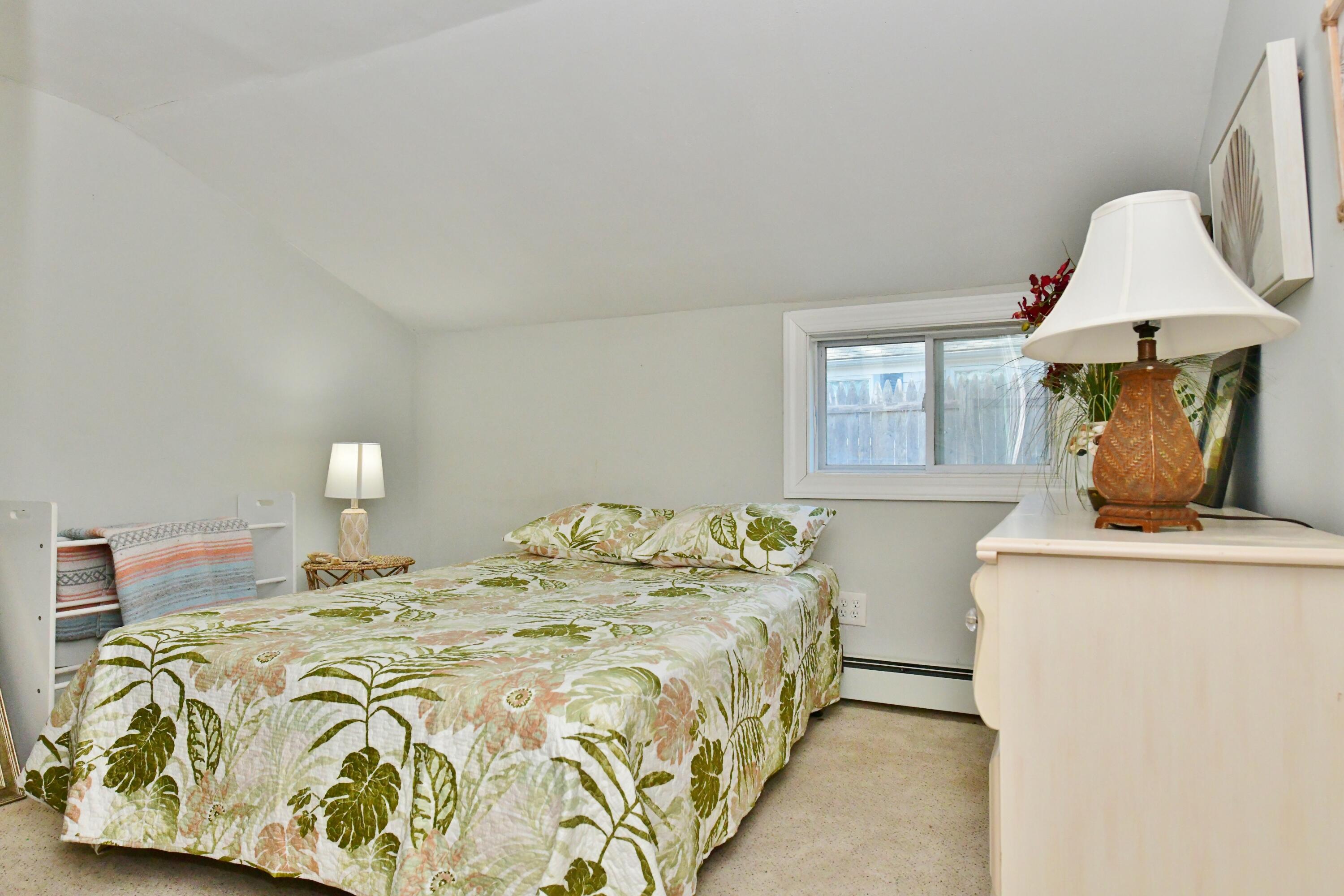 26 Old Monument Neck Road Bourne, MA 02532 - Photo 26 of 51 a bedroom with a bed and window