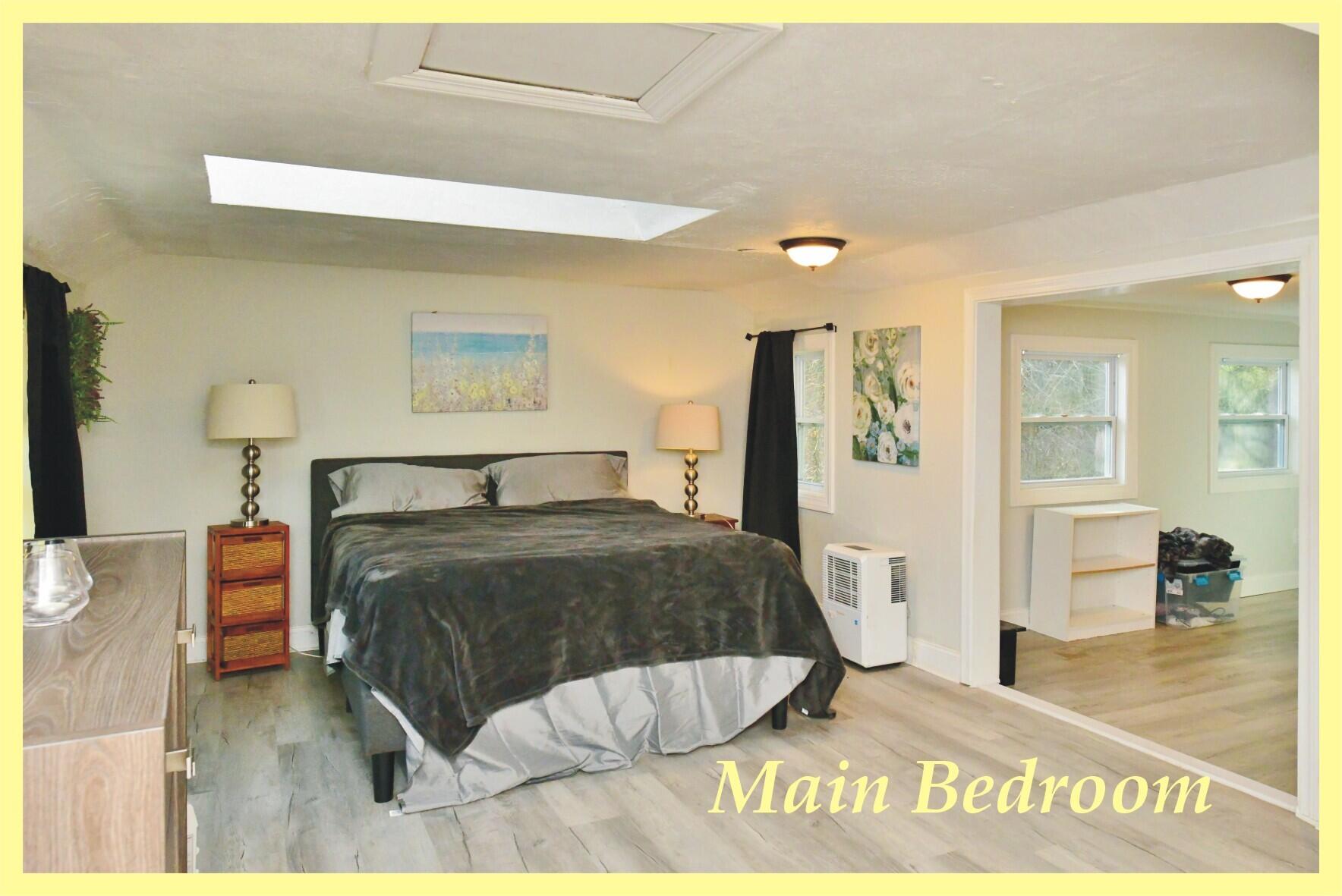 26 Old Monument Neck Road Bourne, MA 02532 - Photo 28 of 51 a bedroom with a bed and wooden floor