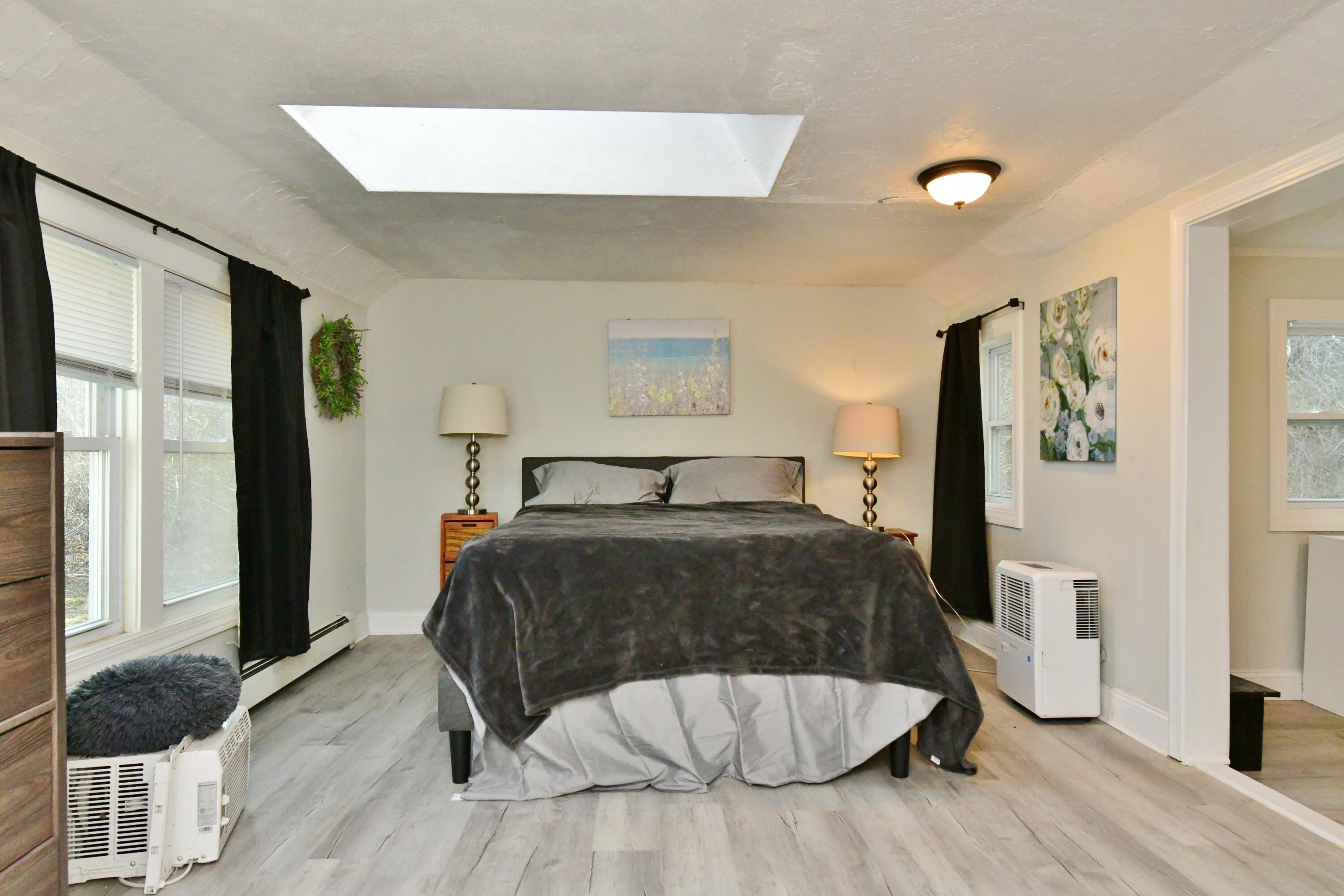 26 Old Monument Neck Road Bourne, MA 02532 - Photo 29 of 51 a bedroom with a bed and a dresser