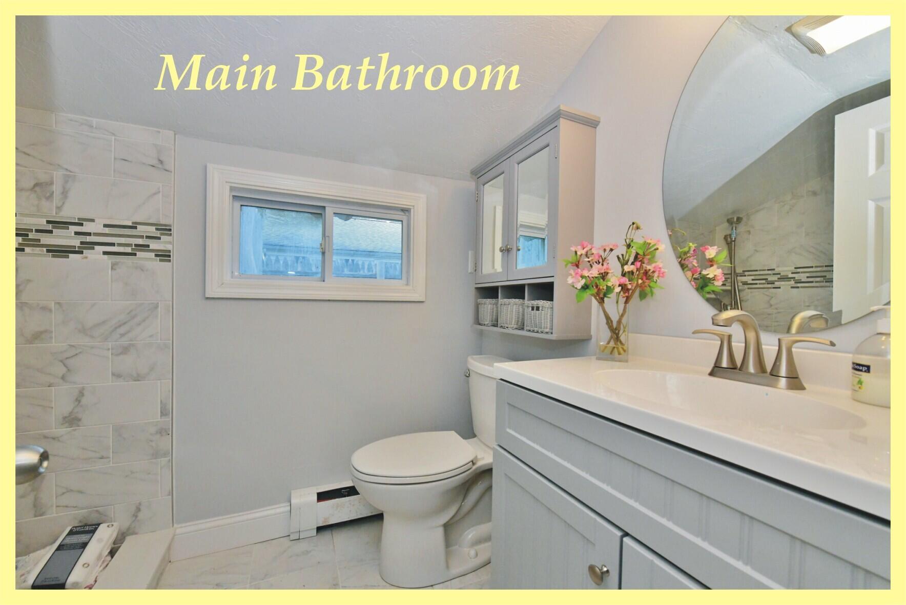 26 Old Monument Neck Road Bourne, MA 02532 - Photo 35 of 51 a bathroom with a granite countertop toilet sink and mirror