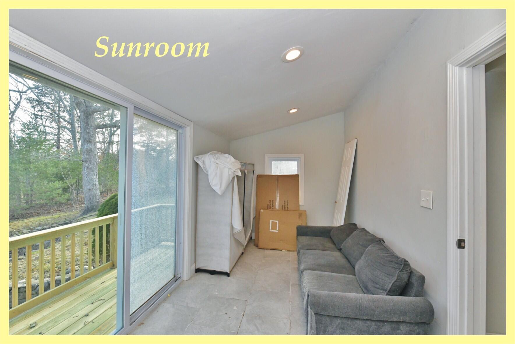 26 Old Monument Neck Road Bourne, MA 02532 - Photo 38 of 51 a living room with furniture and a floor to ceiling window