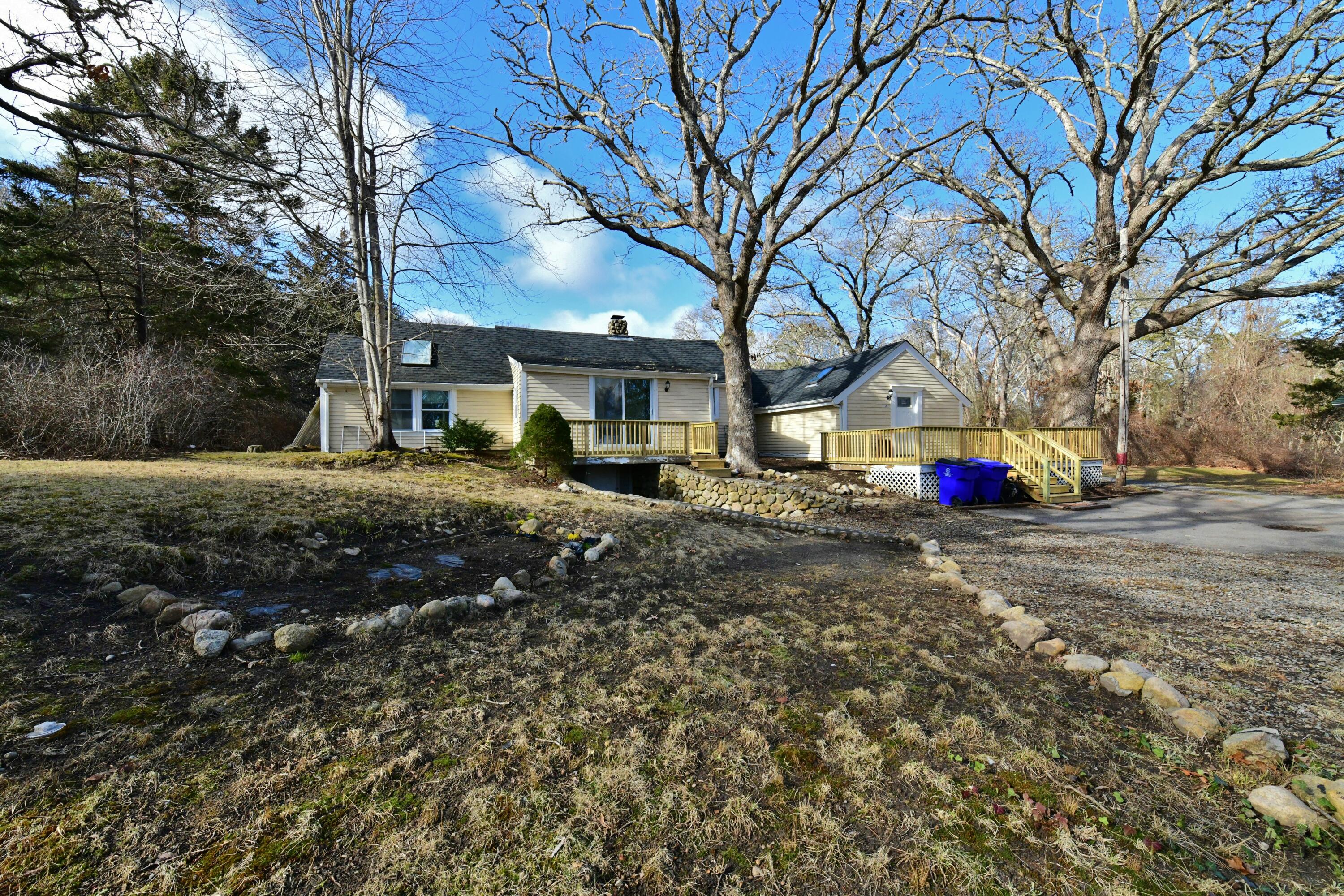 26 Old Monument Neck Road Bourne, MA 02532 - Photo 46 of 51 a street view with large trees