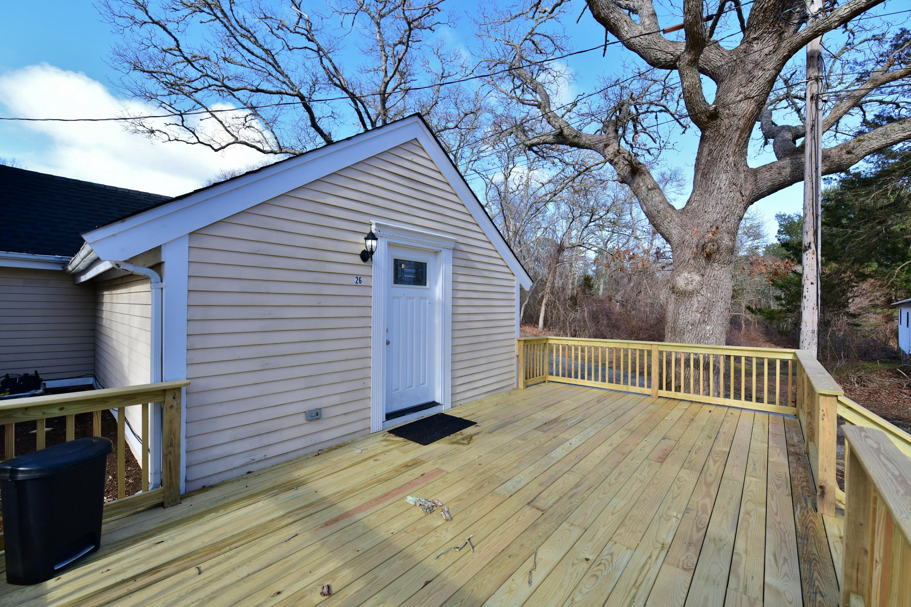 26 Old Monument Neck Road Bourne, MA 02532 - Photo 5 of 51 a view of backyard with a deck and wooden floor