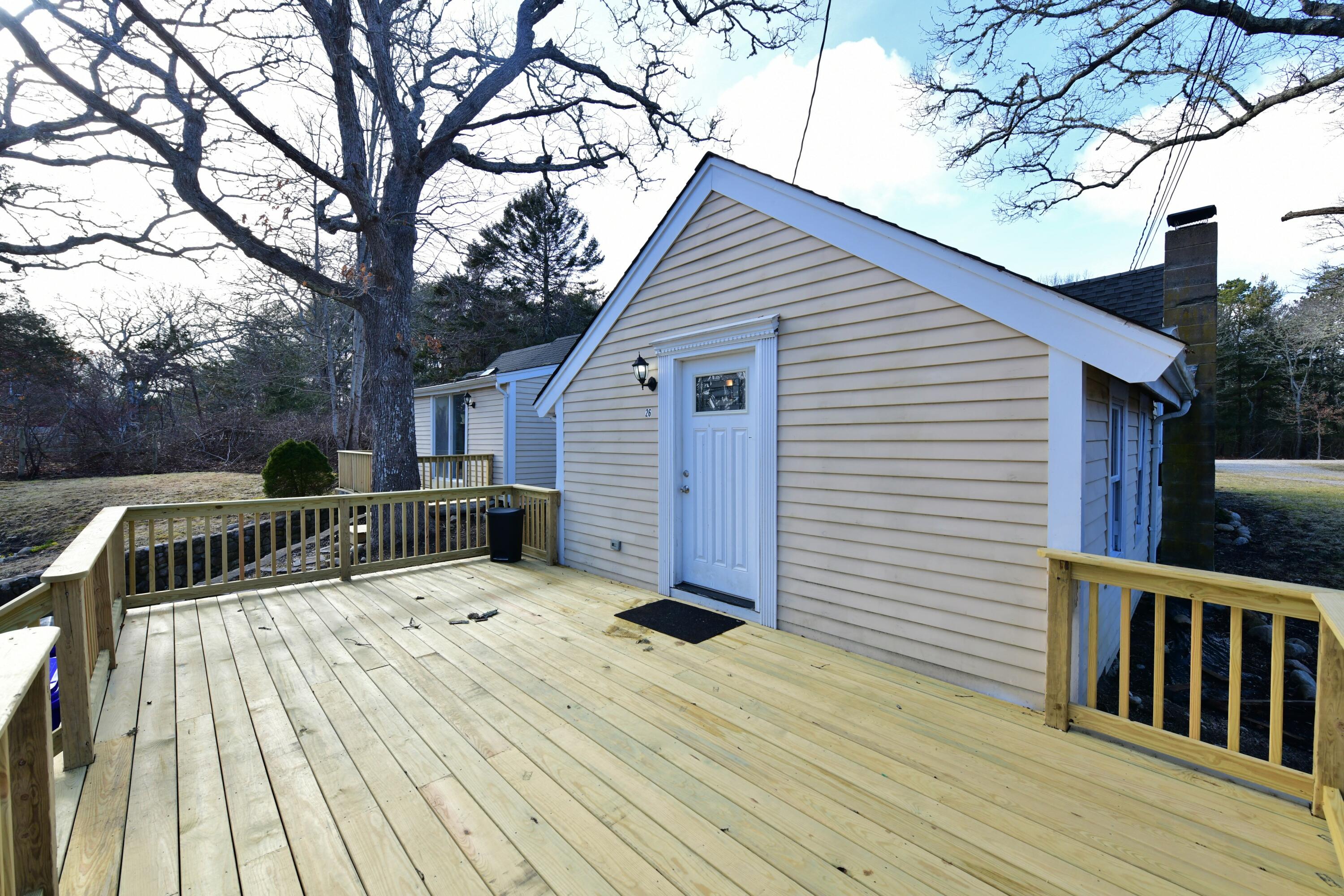 26 Old Monument Neck Road Bourne, MA 02532 - Photo 6 of 51 a view of backyard with a deck and wooden floor