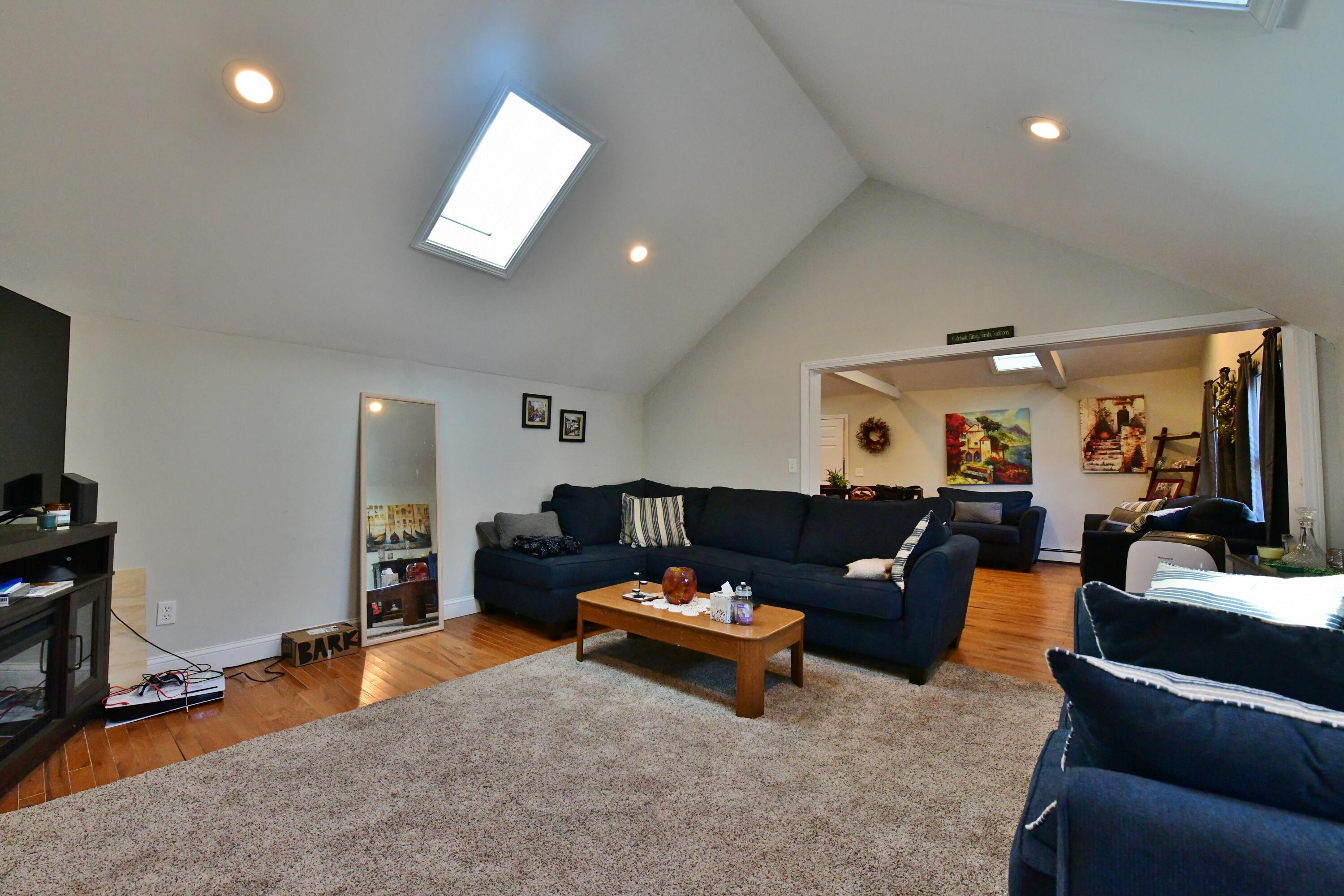 26 Old Monument Neck Road Bourne, MA 02532 - Photo 7 of 51 a living room with furniture and a flat screen tv