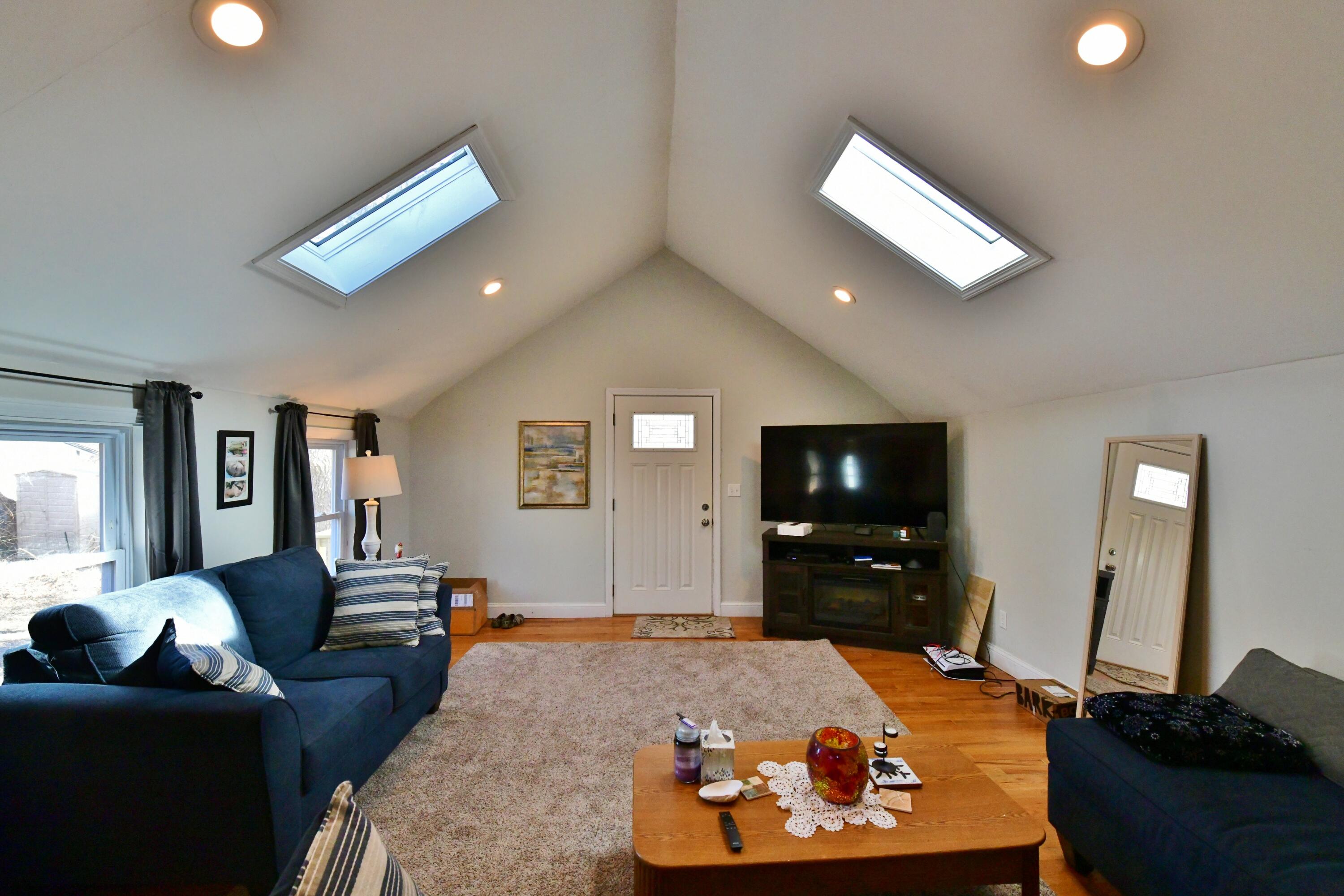 26 Old Monument Neck Road Bourne, MA 02532 - Photo 8 of 51 a living room with furniture and a flat screen tv