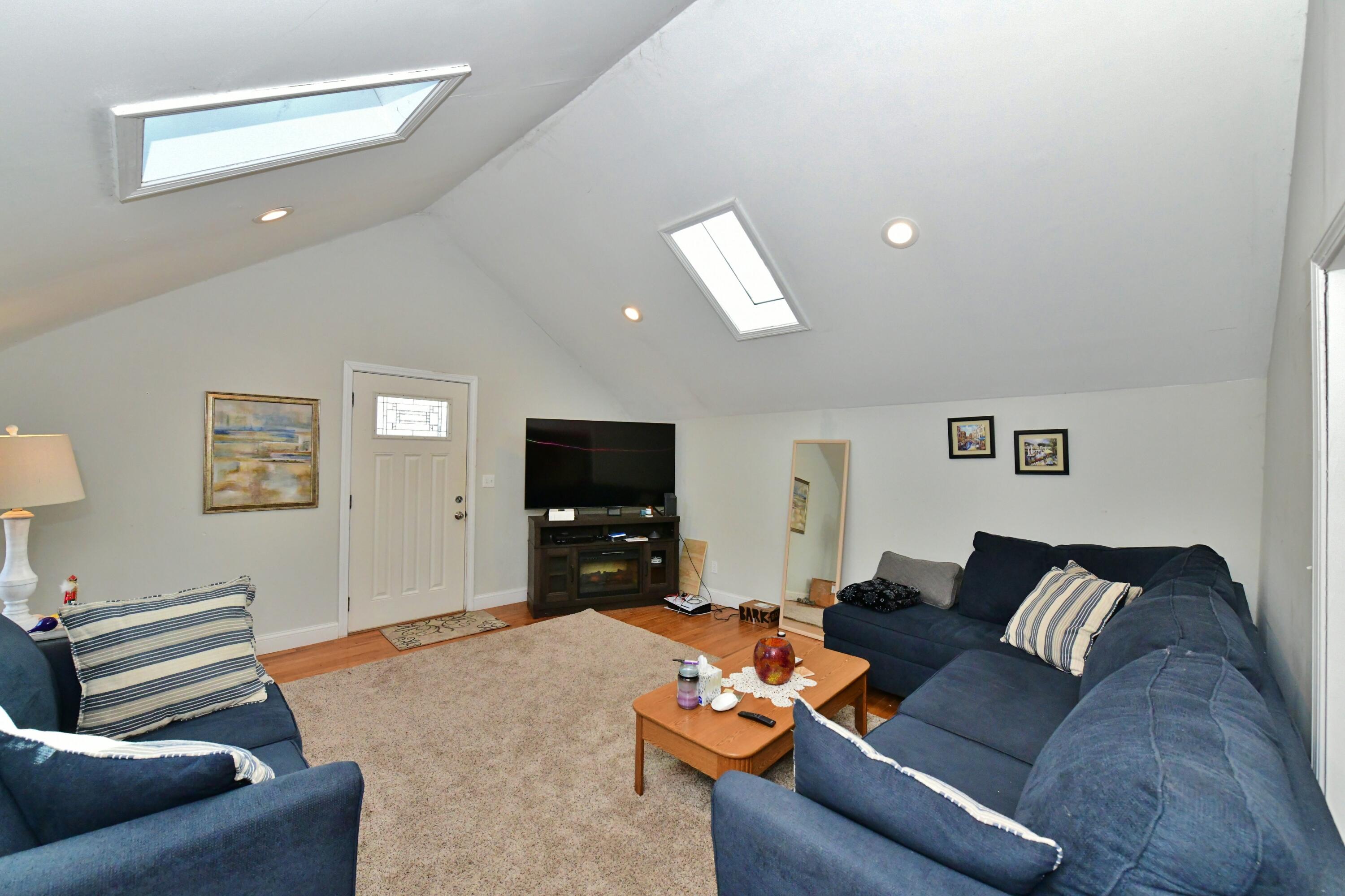 26 Old Monument Neck Road Bourne, MA 02532 - Photo 10 of 51 a living room with furniture and a flat screen tv