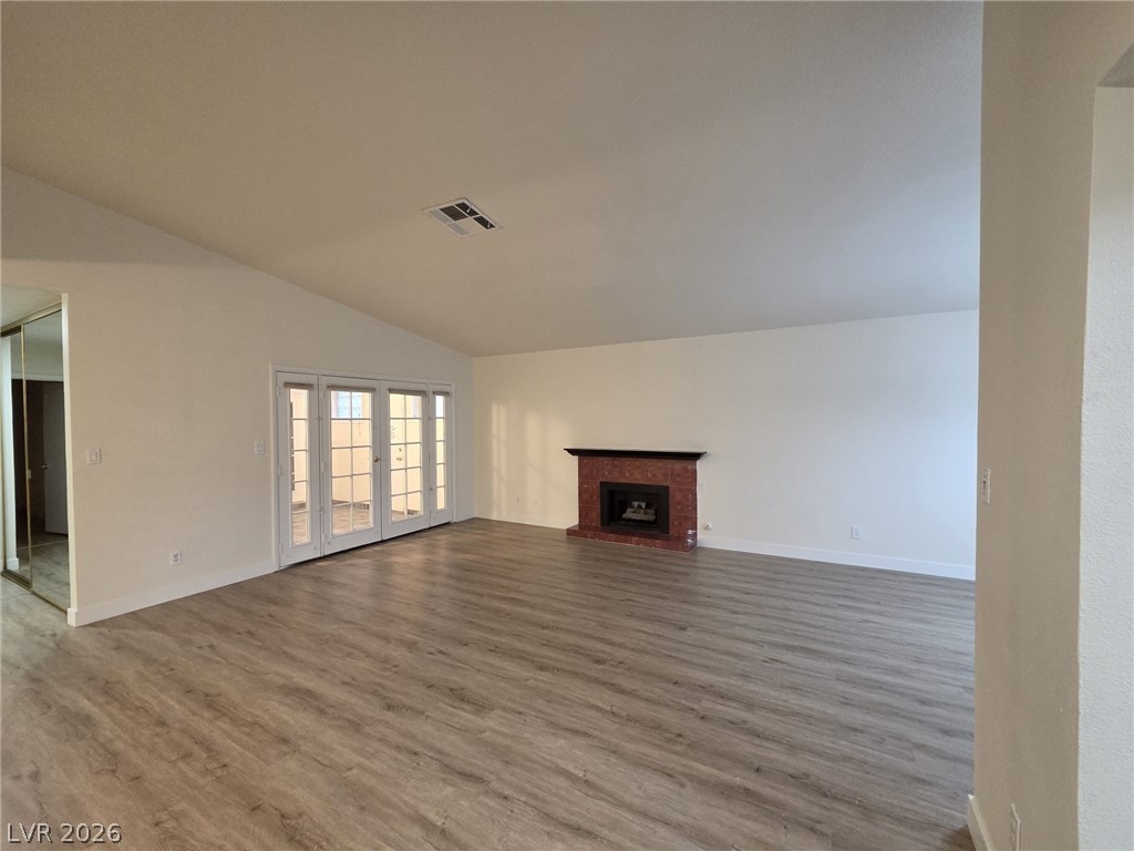 3317 Racquet Street Las Vegas, NV 89121 - Photo 3 of 23 This expansive living area features a warm fireplace and French doors leading to outdoor leisure.