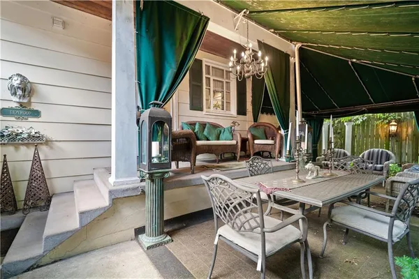a view of a patio with table and chairs and potted plants
