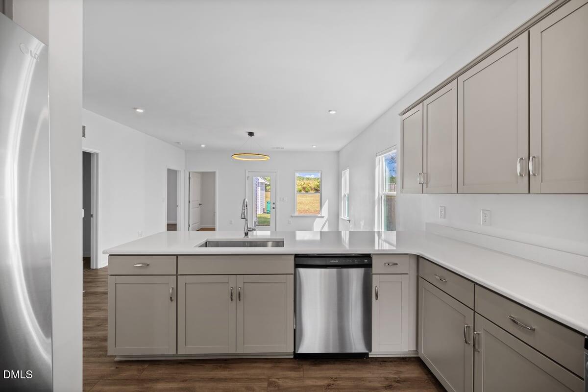3616 Cross Timber Lane Raleigh, NC 27603 - Photo 10 of 39 a kitchen with a sink dishwasher and cabinets with wooden floor