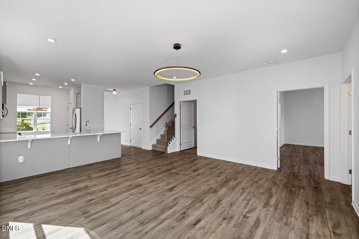 3616 Cross Timber Lane Raleigh, NC 27603 - Photo 12 of 39 a view of empty room with wooden floor and fan