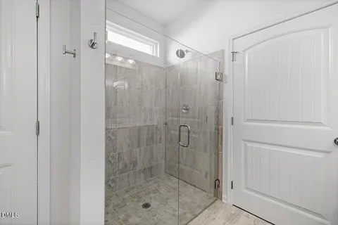 a bathroom with a double vanity sink mirror and shower