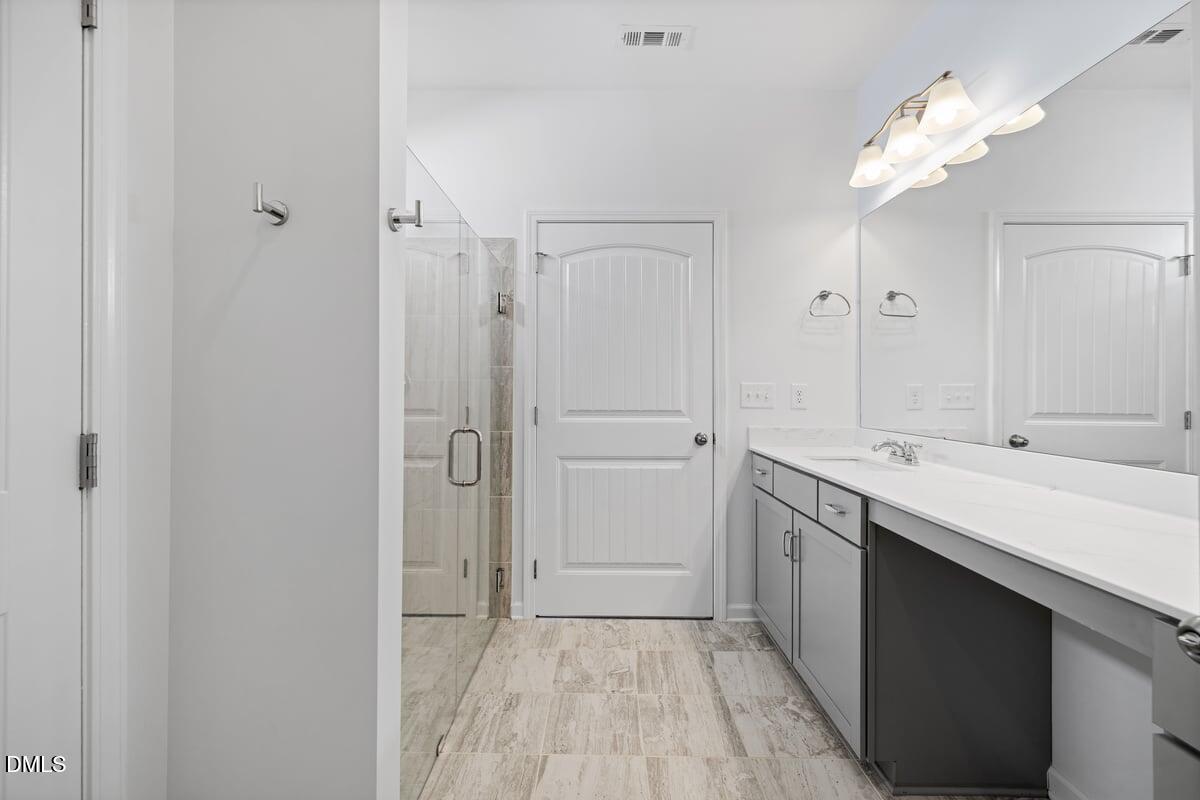 3616 Cross Timber Lane Raleigh, NC 27603 - Photo 18 of 39 a bathroom with a double vanity sink mirror and shower