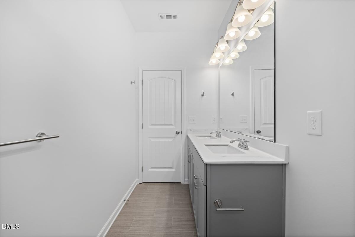 3616 Cross Timber Lane Raleigh, NC 27603 - Photo 28 of 39 a bathroom with a sink and a mirror