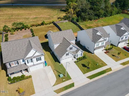an aerial view of residential houses with yard