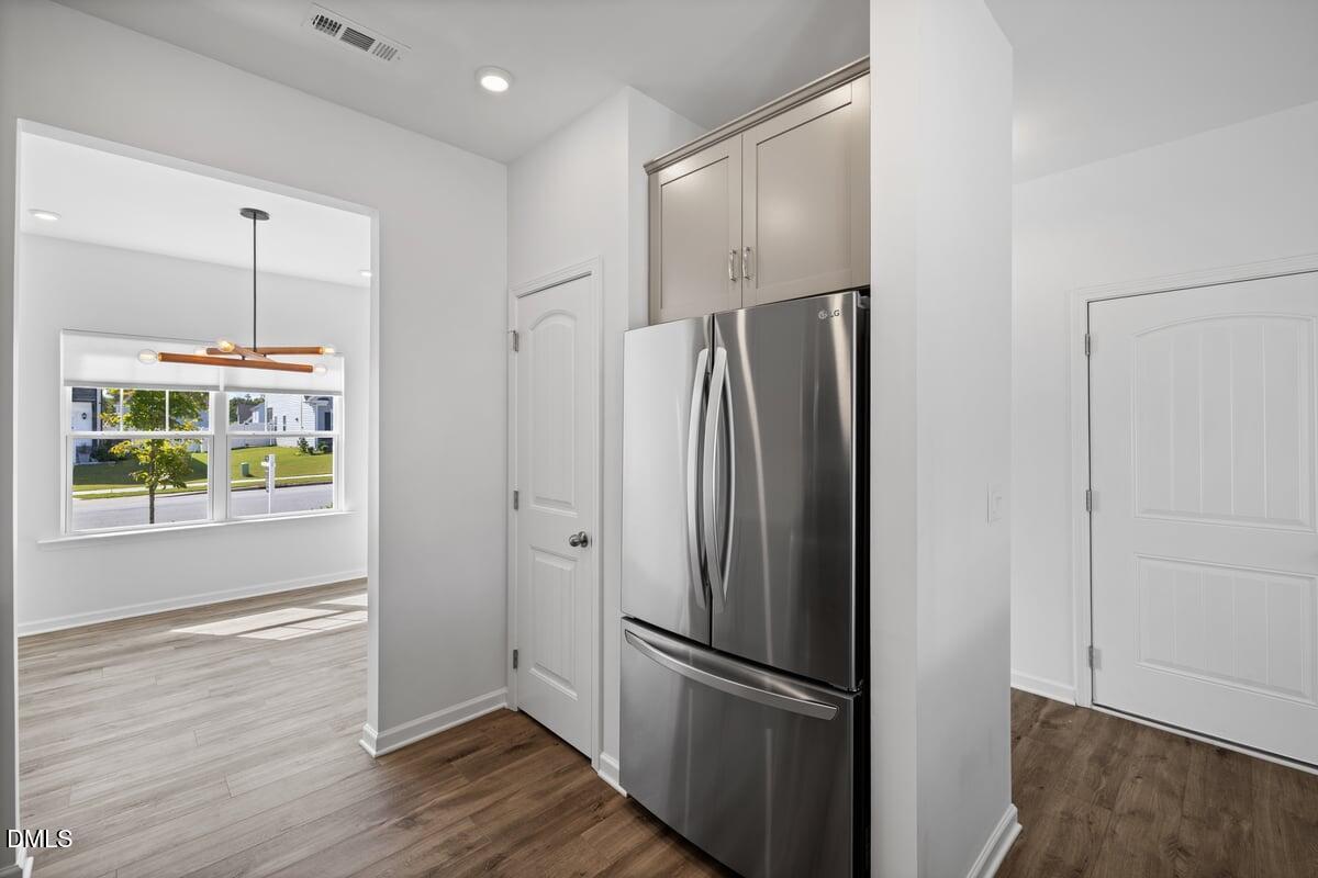 3616 Cross Timber Lane Raleigh, NC 27603 - Photo 9 of 39 a view of a refrigerator in kitchen and an empty room