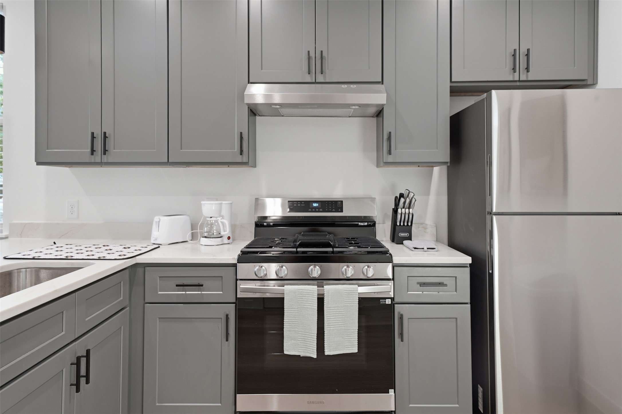 2216 Yellow Jacket Lane, Unit 2 Austin, TX 78741 - Photo 12 of 25 a kitchen with stainless steel appliances granite countertop a stove a refrigerator and a white cabinets