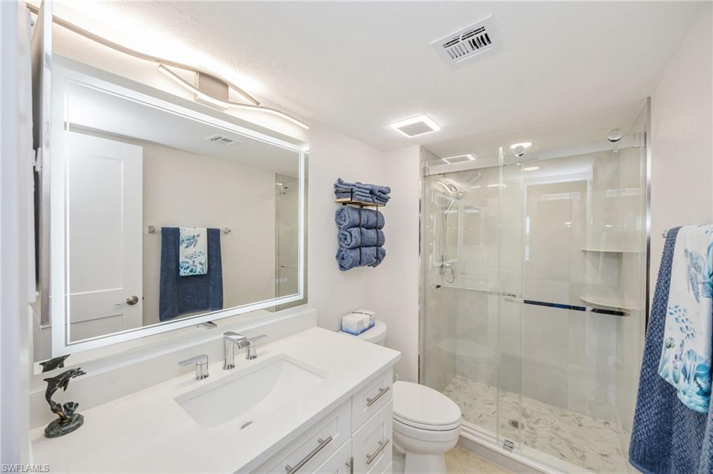 309 Goodlette-Frank Road, Unit A406 Naples, FL 34102 - Photo 10 of 20 a bathroom with a sink a toilet and shower
