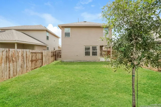 a view of a house with a backyard